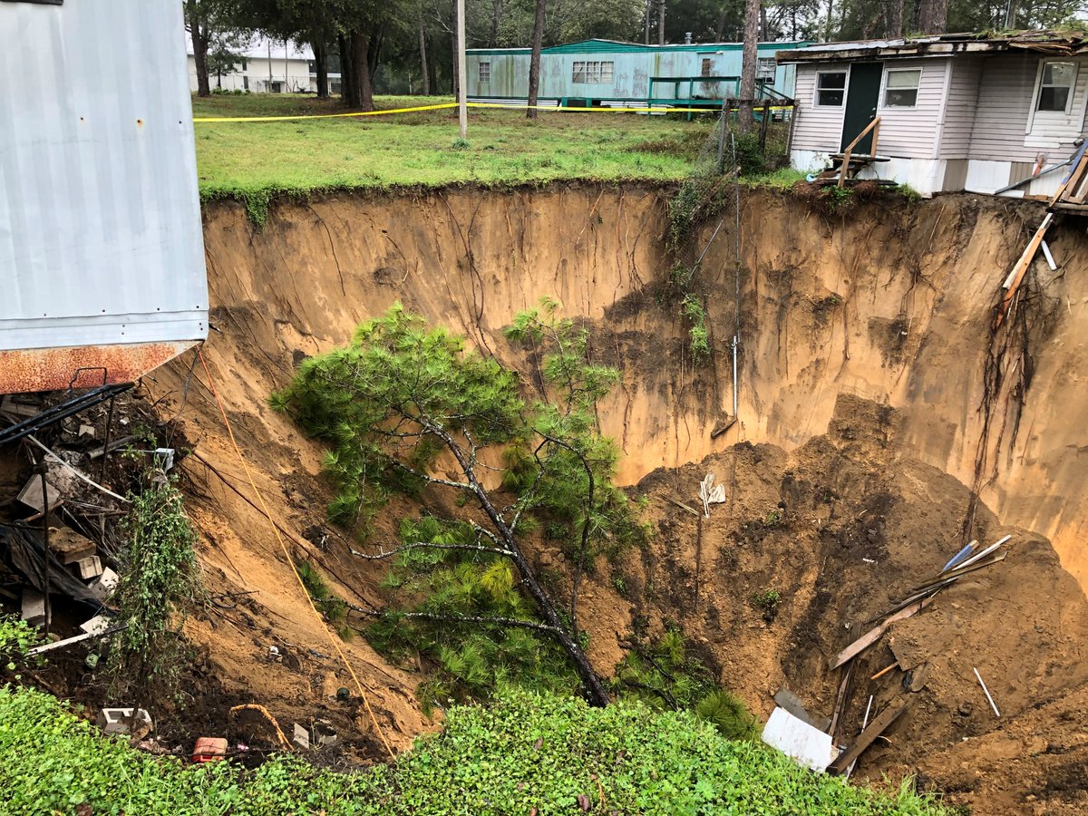 massive sinkhole that's threatening to take out at least one Tallahassee home in Capital Circle Pines mobile home park near Capital Circle SW and Crawfordville Highway.