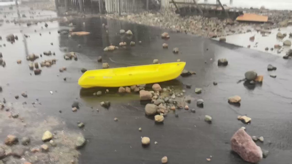 A kayak, steps ripped off, rocks in the road. Rebecca Road in Scituate