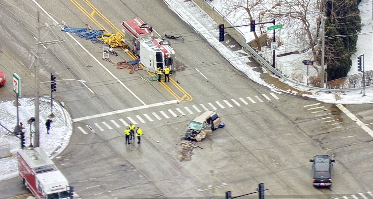 Accident involving a minivan and a fire truck on its side in Palatine shutting down the intersection of Palatine Rd & Quentin Rd