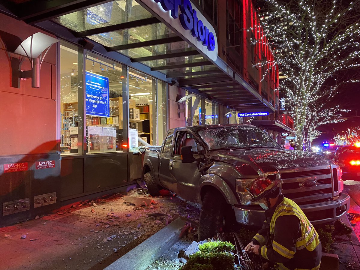 Officers are responding to a truck driver who lost control on Bellevue Way. The driver spun and hit The Container Store, shattering the window.