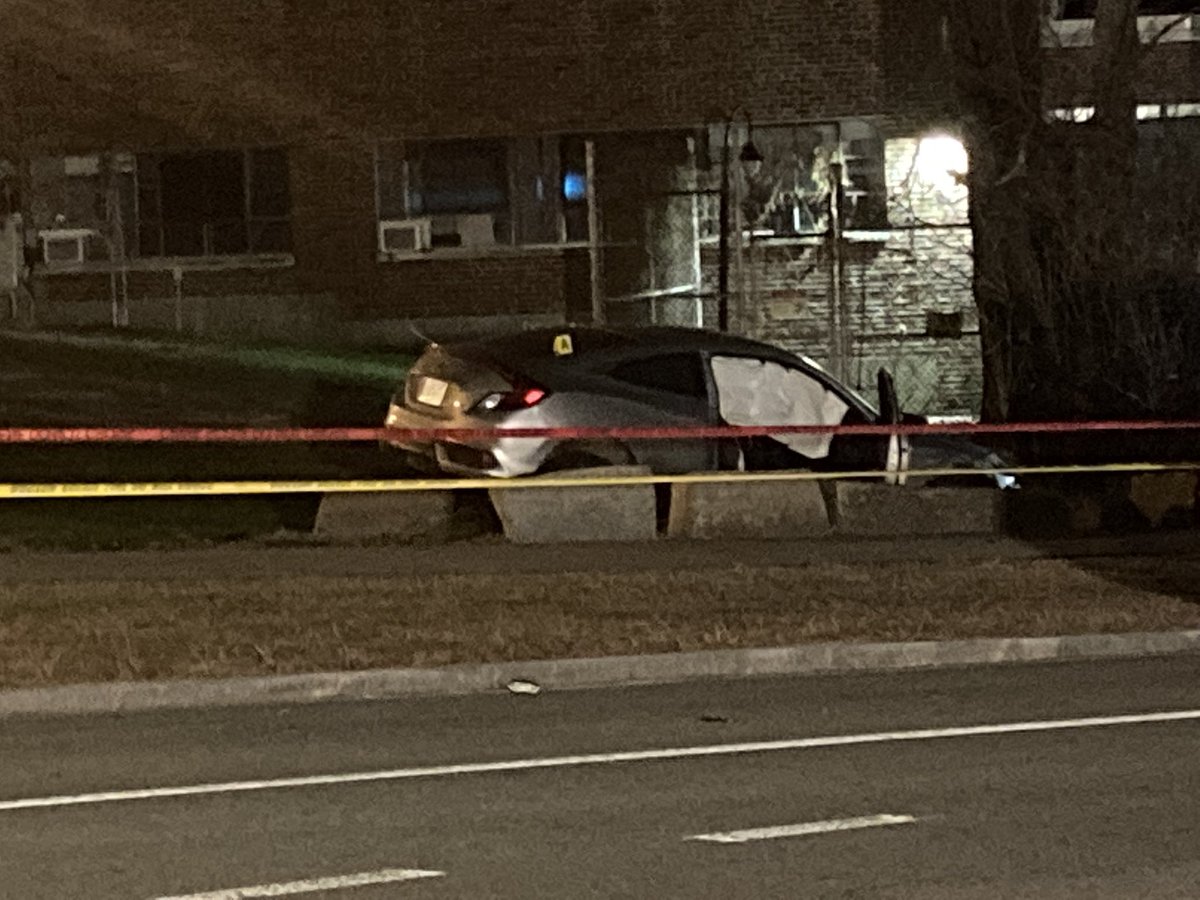 At the scene of a police-involved shooting in JP, police tape surrounds a vehicle, evidence market on top, side-airbag appears to be deployed. Police say suspect opened fire on officers. Suspect has life-threatening injuries. Officers okay