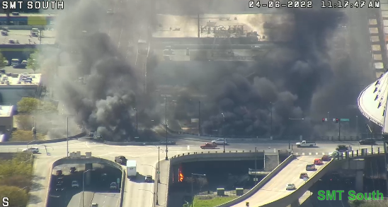 Large fire on 4th Ave S  at Edgar Martinez Dr S under the overpass. Use caution in the area due to decreased visibility. Use alternate routes and expect delays due to responders in the area