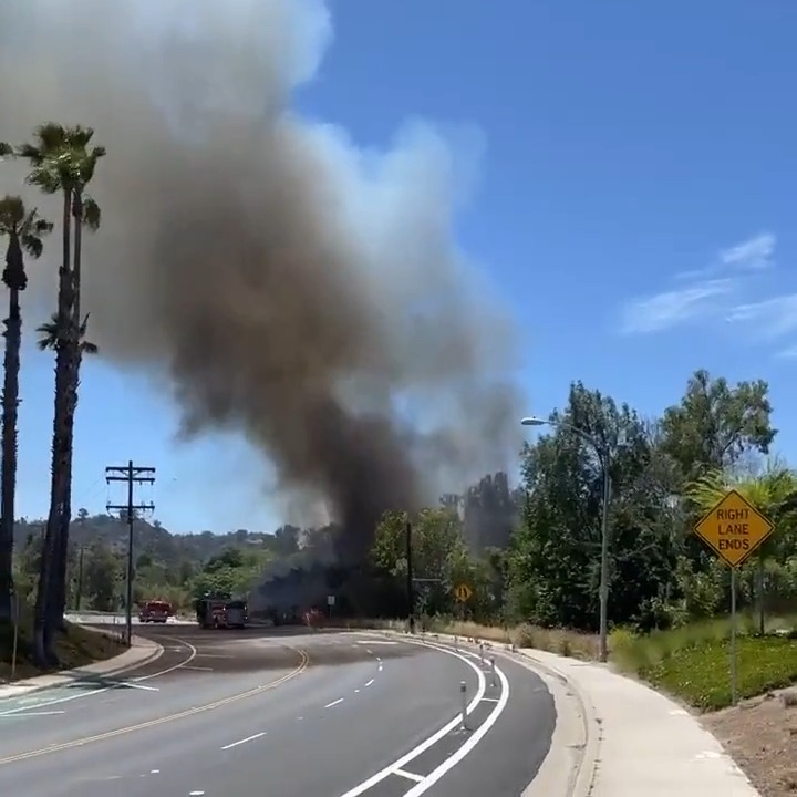 Firefighters are battling a brush fire burning at a rapid rate of spread in heavy brush in the Grantville area of San Diego. Radio traffic indicates the fire has already burned about half an acre in a riverbed. Additional resources requested for road closures