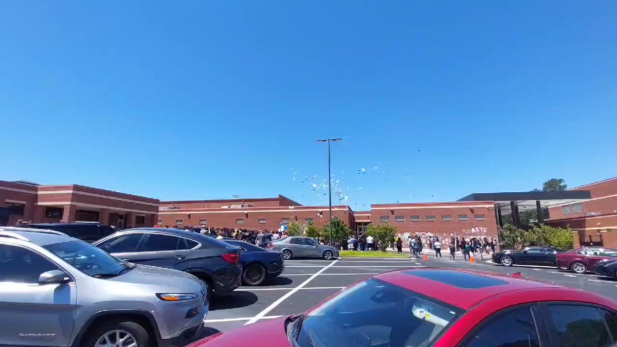 Students and staff  release balloons at Eagles Landing High in McDonough Thursday in honor of 3 students killed in car crash