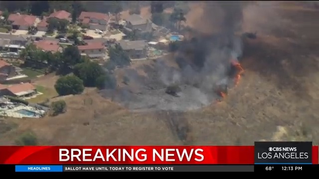 Fire crews are working to contain a brush fire burning near the 60 Freeway in the Diamond Bar area