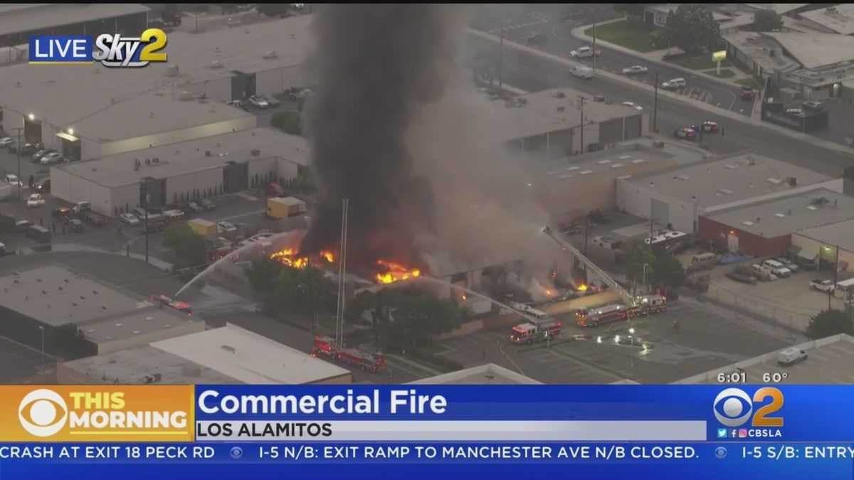 Firefighters are battling a second-alarm blaze at a building in an industrial area of Los Alamitos
