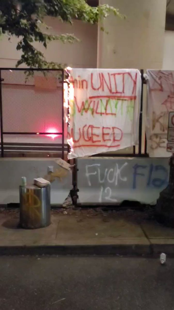 Banner burning outside the Portland federal courthouse. It was relatively uneventful night, no reported arrests in Portland