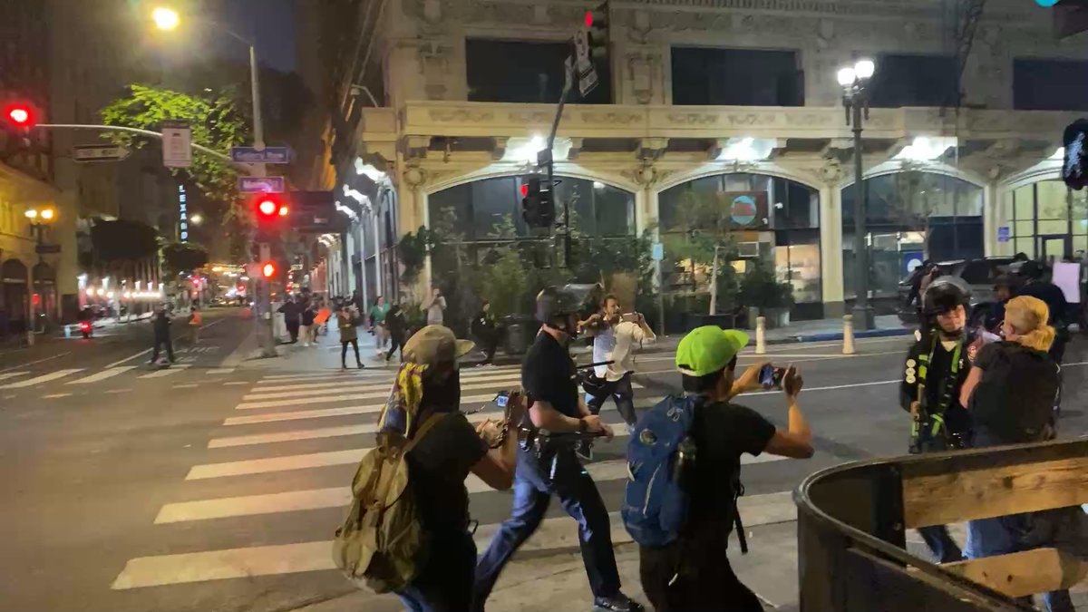 Police manhandle reporter @TinaDesireeBerg, who gets up and continues to report after being thrown to the ground.