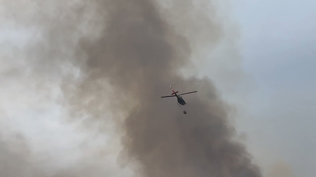 Helicopters dropping water over flames at Hwy 74 and Blackburn Road in Hemet. Cal Fire now says this fire has burned through 20K acres. Wind is shifting out here and will remain a challenge throughout the night