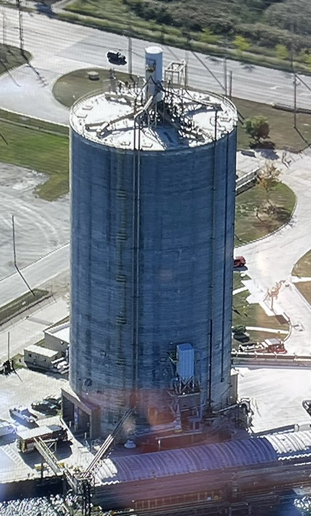 Chicago Fire Department Squad Co. members on scene at the south end of Calumet Harbor off 130th. 2 men have become stuck in an external elevator, 150' up a 200' dry cement storage silo. The 2 are fine and the CFD is here to make sure they stay ok. More at