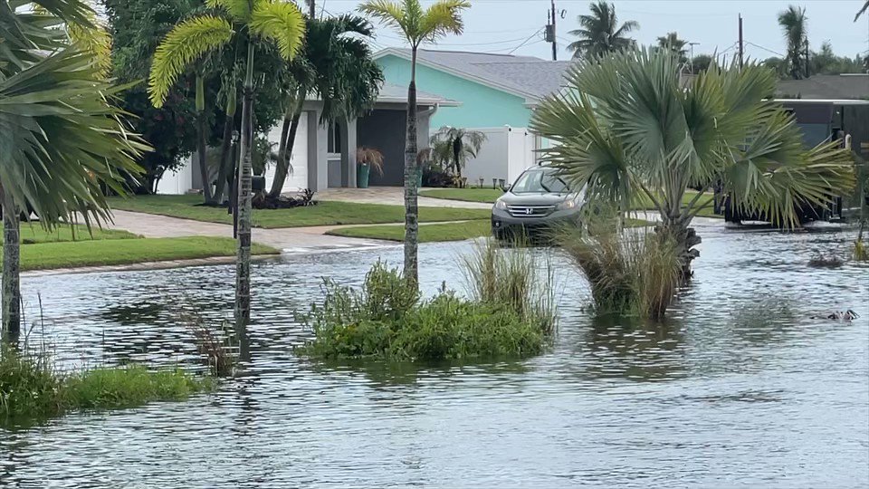 A look at vehicles trying to navigate flooded DeSoto Parkway in SatelliteBeach