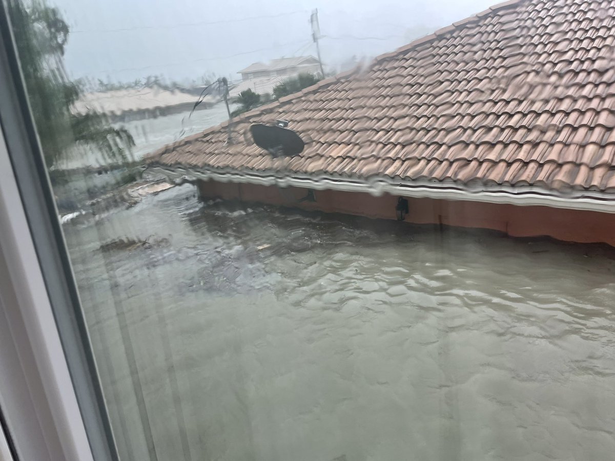 Threatening storm surgenear the roof of 1 story homes