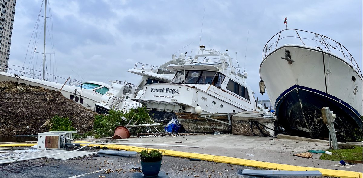 In a scene reminiscent of post-Irma Miami's waterfront, boats carried ashore by storm surge during HurricaneIan run aground in Fort Myers parking lots and streets