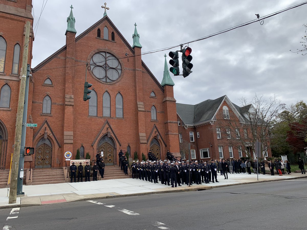 New Haven Fire firefighters gathering outside of St. Francis Church ahead of the funeral for 27 Y.O. Thomas Mieles. Mieles was killed while off-duty earlier this month in a multi-car crash on 91.