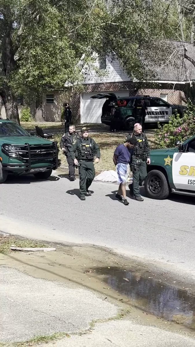 Suspect taken into custody after U.S Marshals, Pensacola Police and Escambia County deputies serve a warrant at a home on Ellysee Way. We captured video of him being placed in a patrol car