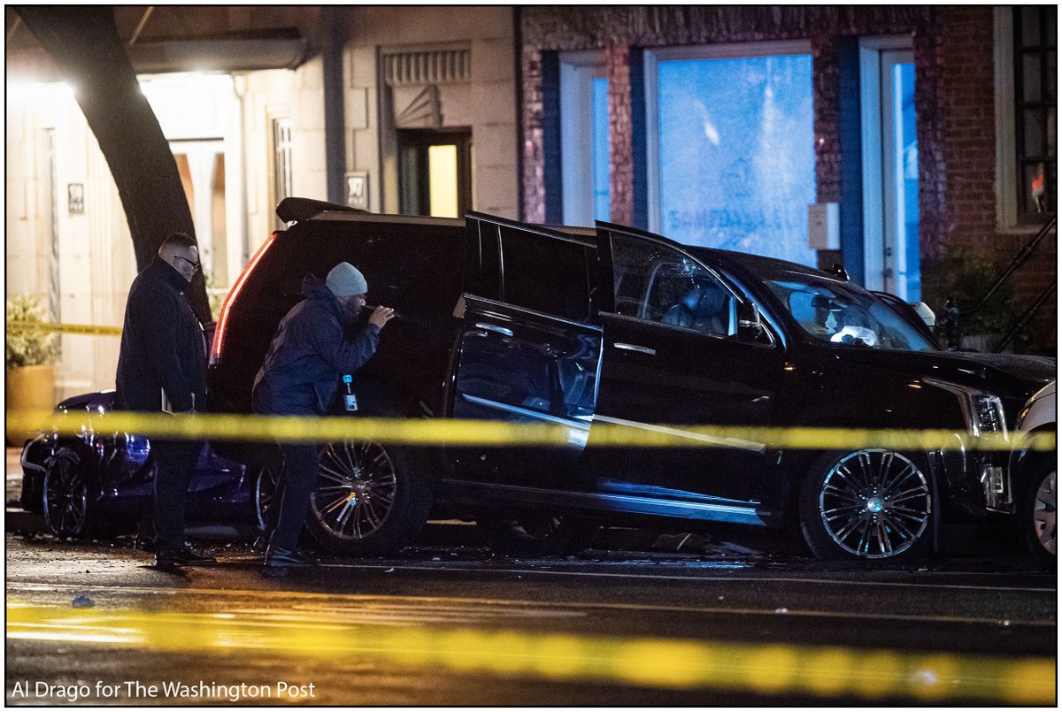 Members of the Metropolitan Police Department investigate a black SUV that crashed into parked cars following a shooting on the 400 block of 11th Street SE on Sunday. One male was pronounced dead at the scene and a 2nd male succumbed to their injuries on the way to the hospital
