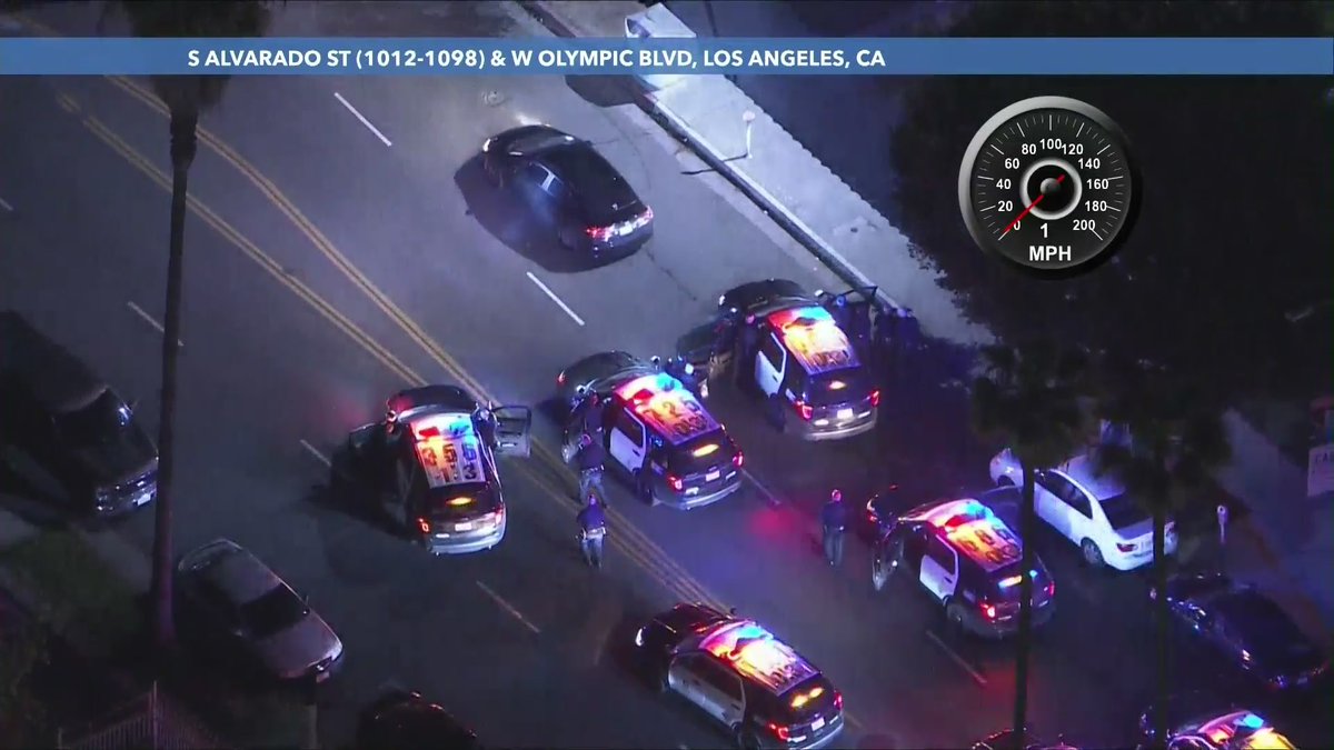 As sparks and smoke shoot out of the vehicle, the driver came to a stop on S. Alvarado and is surrounded by police.