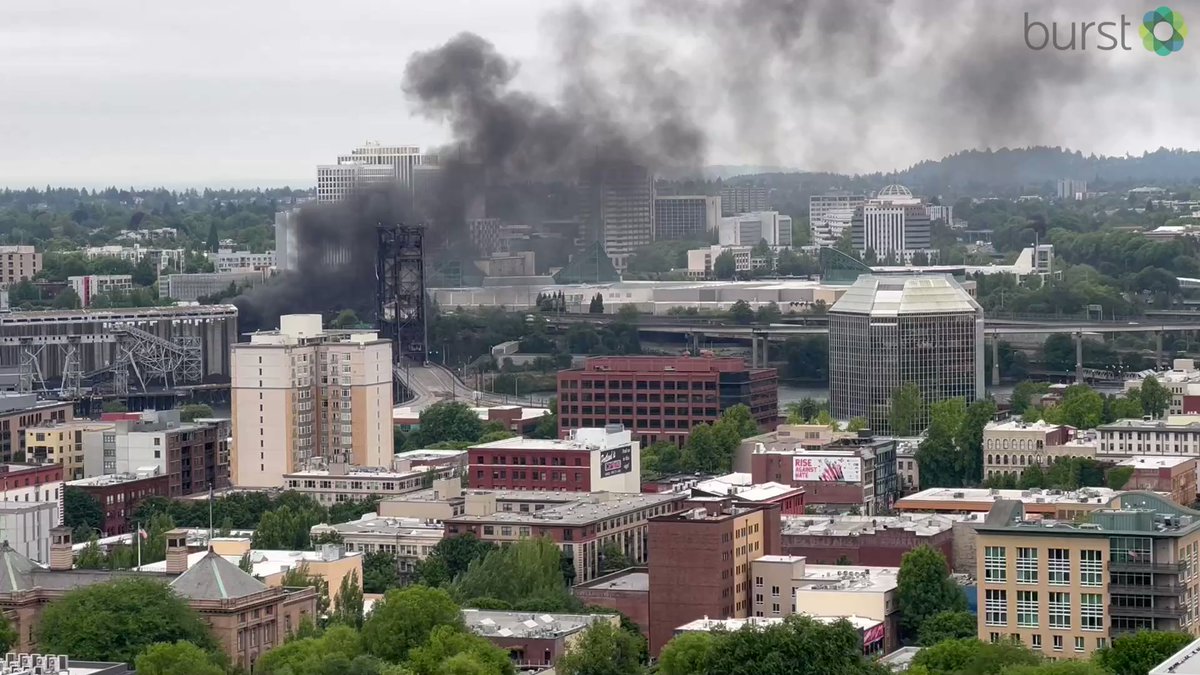 Rubber fire reignites near Steel Bridge sending thick black smoke into the air