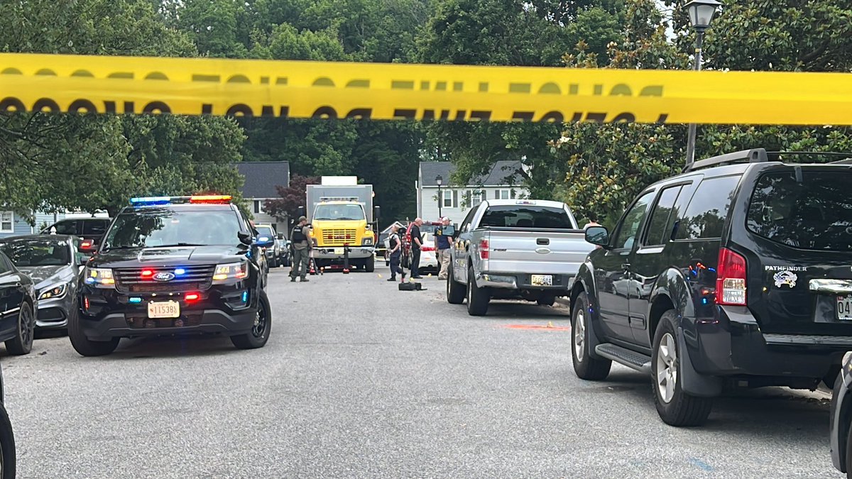 Multiple bullet markers on the ground, and a window blown out of the home where the shooting happened