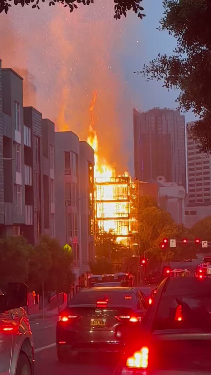 Firefighters contained a four-alarm structure fire in San Francisco Tuesday morning that burned four neighboring buildings and displaced at least eight residents