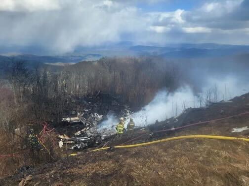 Officials said the airplane involved in the deadly crash at the airport in Bath County was short on its approach to the runway and struck the trees and hillside