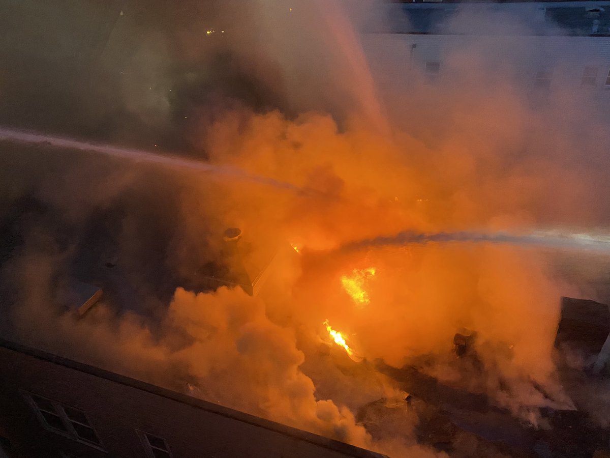 Flames are through the roof of the vacant building