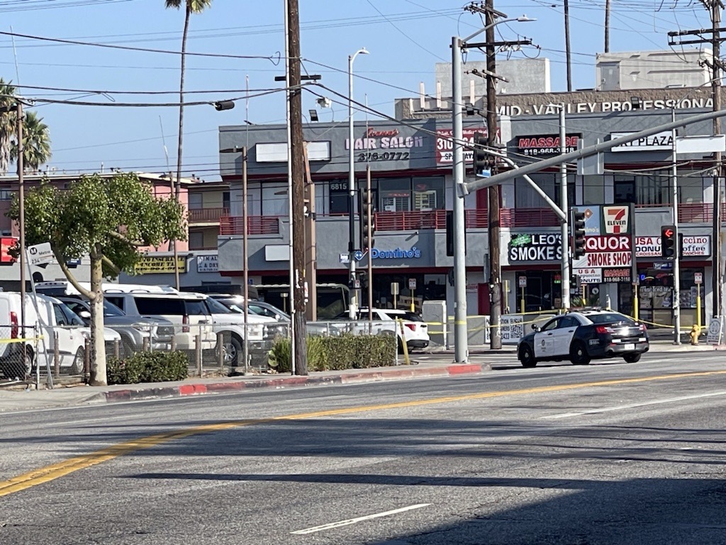 Police in the San Fernando Valley are responding to a 7-Eleven where an armed man has barricaded himself inside one of the store's back rooms