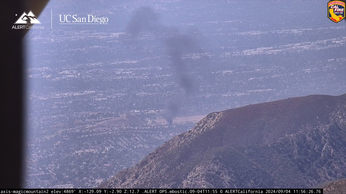 A big rig fire has now spread to the brush on the NB 5fwy at the 405.  The NB truck bypass lanes will be shut down at the 5/405.  Smoke seen here from high above