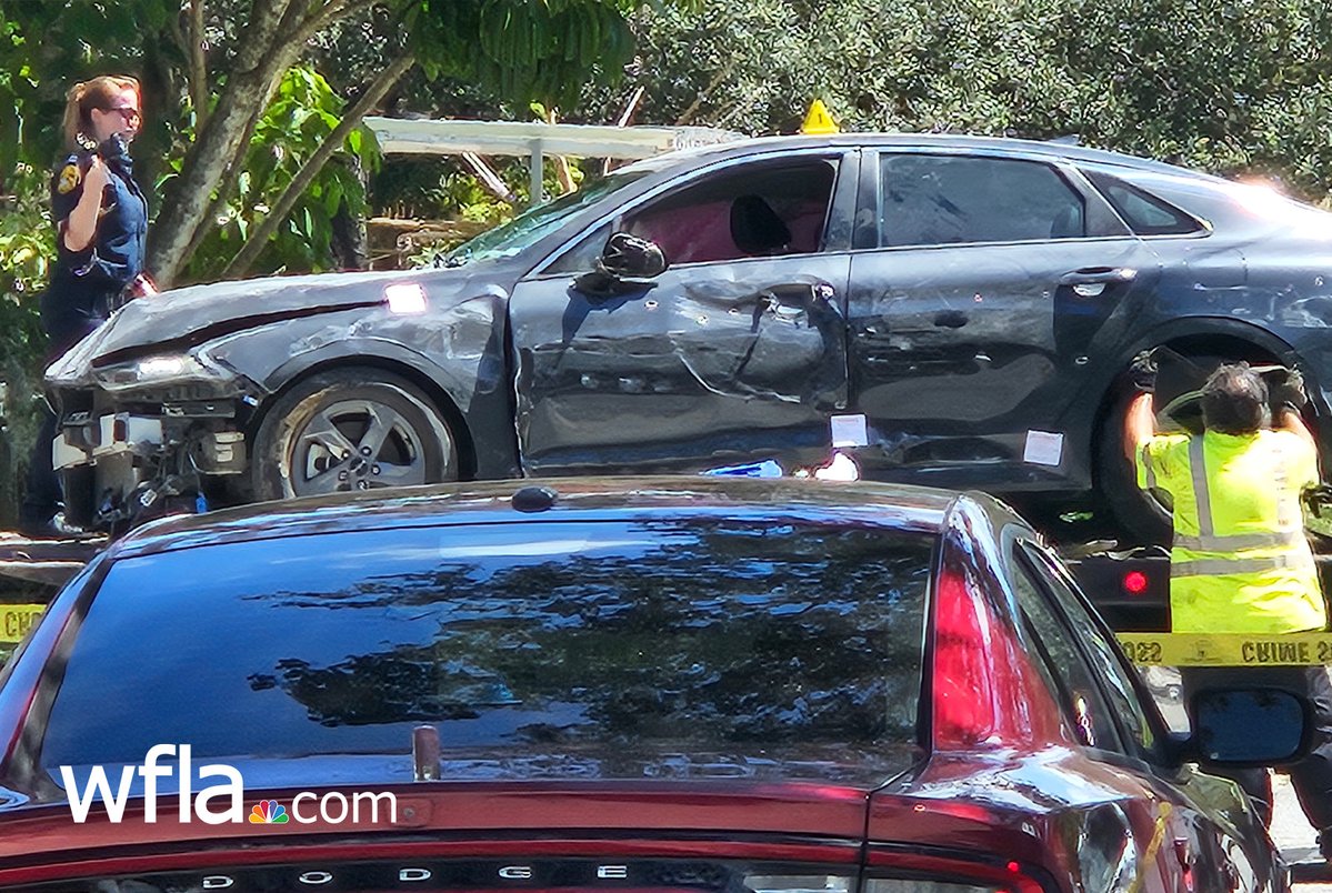 Tampa police have removed a car that crashed into a family's home after its driver was shot this morning. Bullet holes are visible on the side.