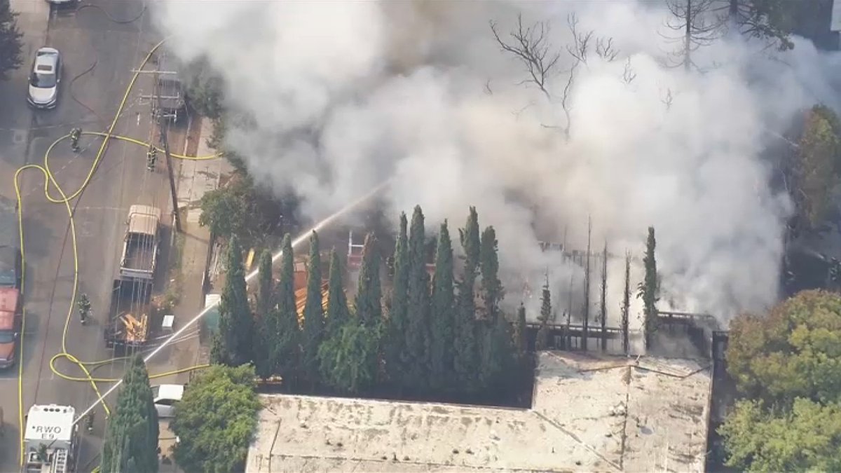 Firefighters are battling a blaze on the 300 block of Poplar Avenue in Redwood City