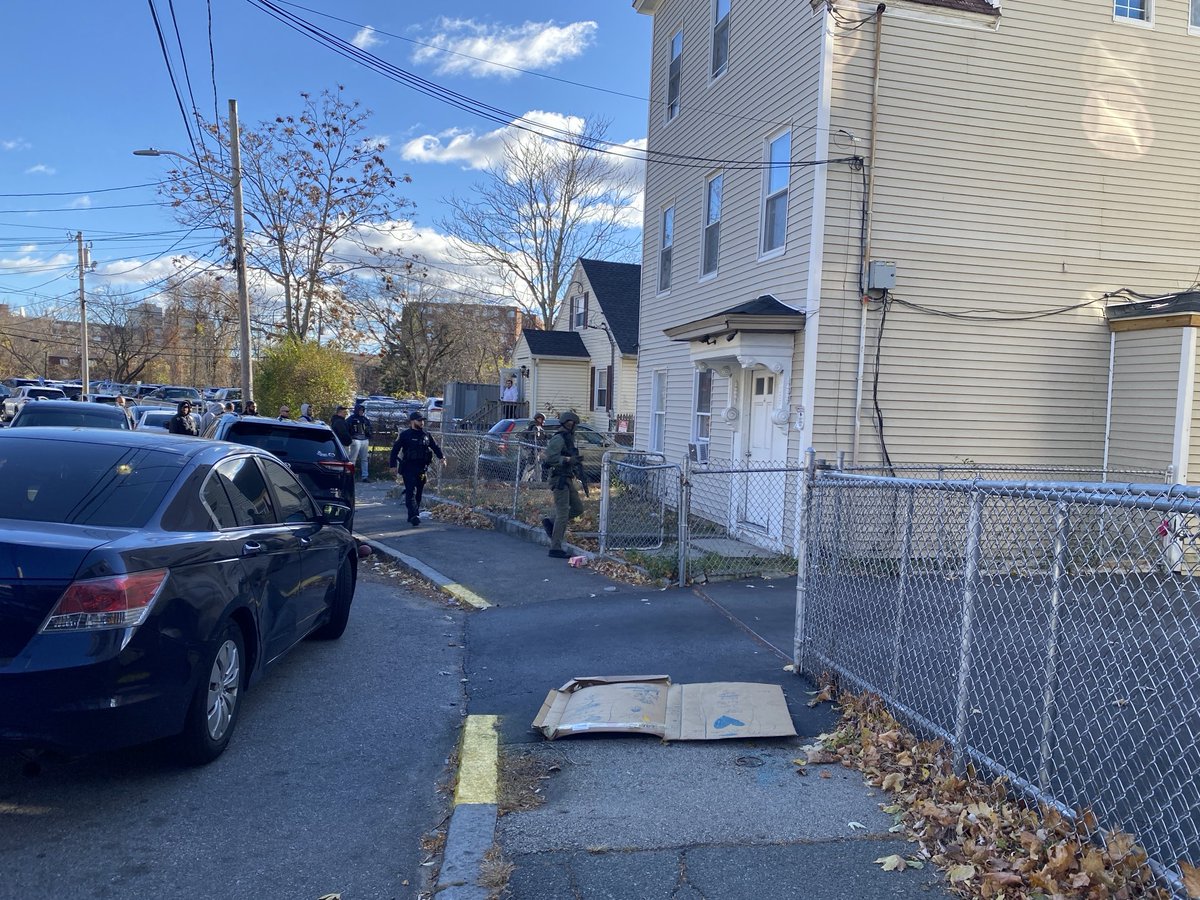 Police with helmets, long guns and battering ram enter apartment building in Lawrence