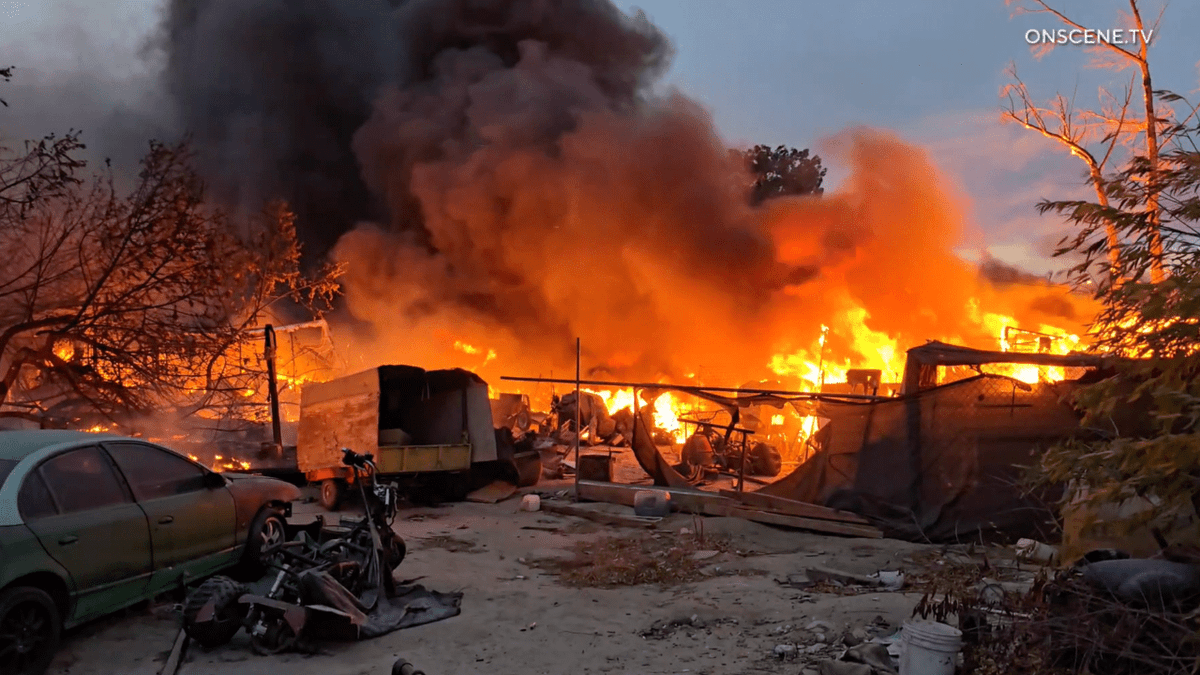 Fire erupts in Santa Ana Riverbed as gusty winds blast Southern California