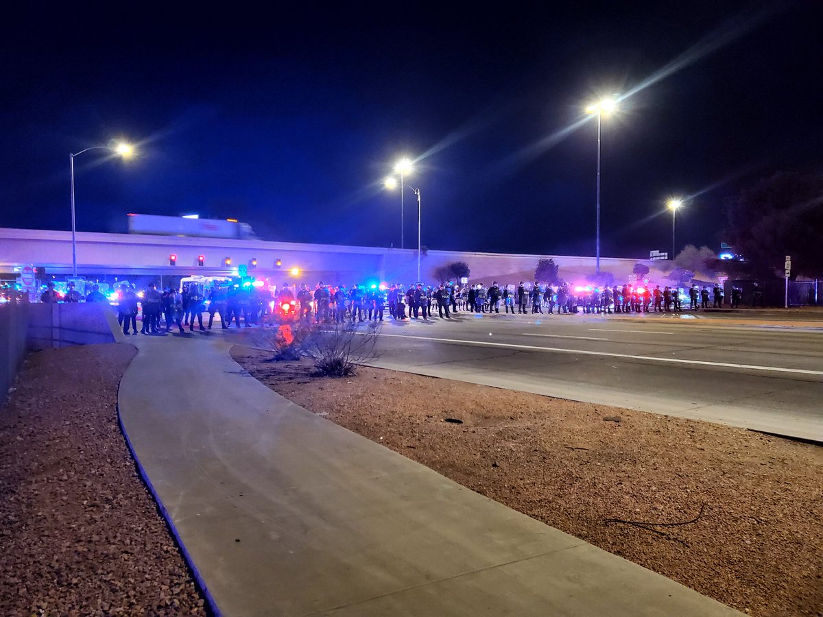 Police in tactical gear and shields drawn are lined up on Glendale Ave. giving commands to a group of protesters headed to the 101 to disperse