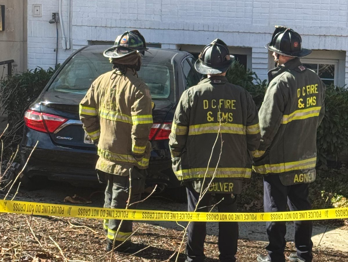 Vehicle striking building 2300 block 41st St NW. 2 occupants of vehicle did not require medical attention. Vehicle partially into basement laundry room. Rescue Squad determined no structural damage. No utilities compromised. No injuries or displacements. DC firefighters