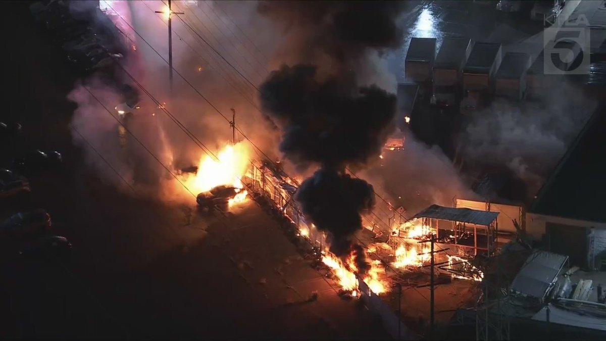 Crews are responding to a large pallet fire that's burned multiple box trucks in Sun Valley