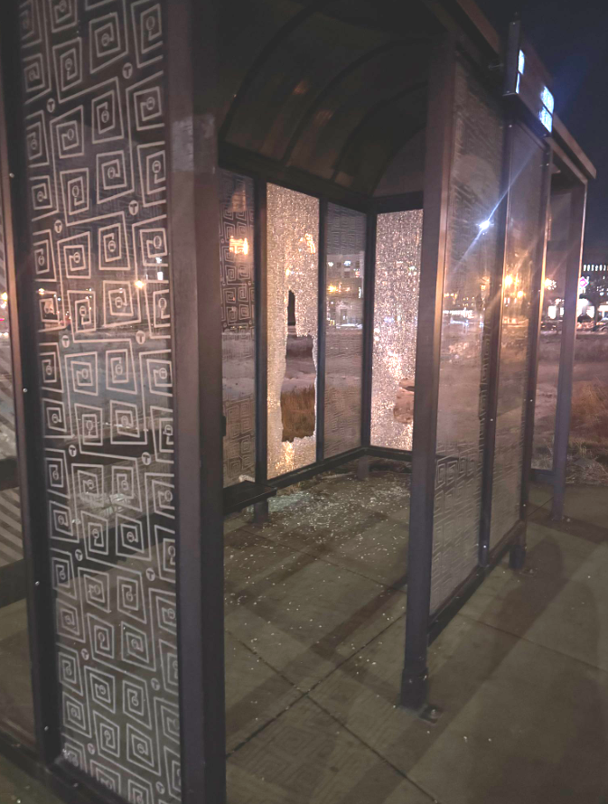 Damaged bus shelter near UMN campus in SE Minneapolis, Oak St and University