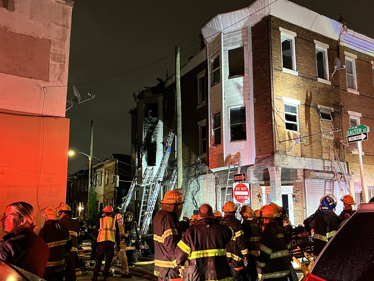 Firefighters comb through the wreckage after flames tear through this South Philadelphia apartment building this morning.  8th St. at Christian St.