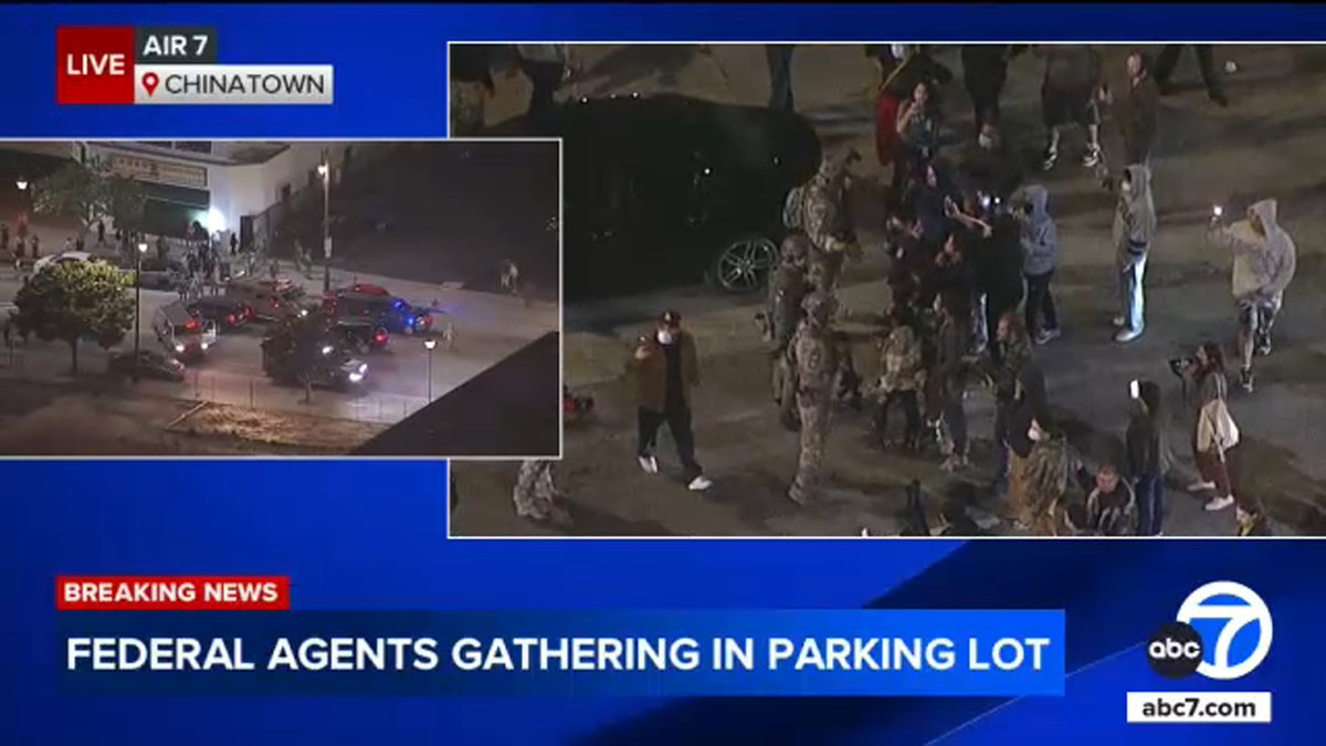 Federal agents are seen gathering in a Chinatown parking lot, prompting a confrontation with residents.
