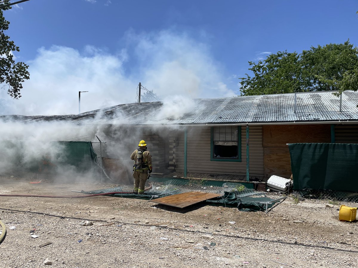 Fire units on scene of abandoned structure 50% involved on fire with partial collapse of the structure.