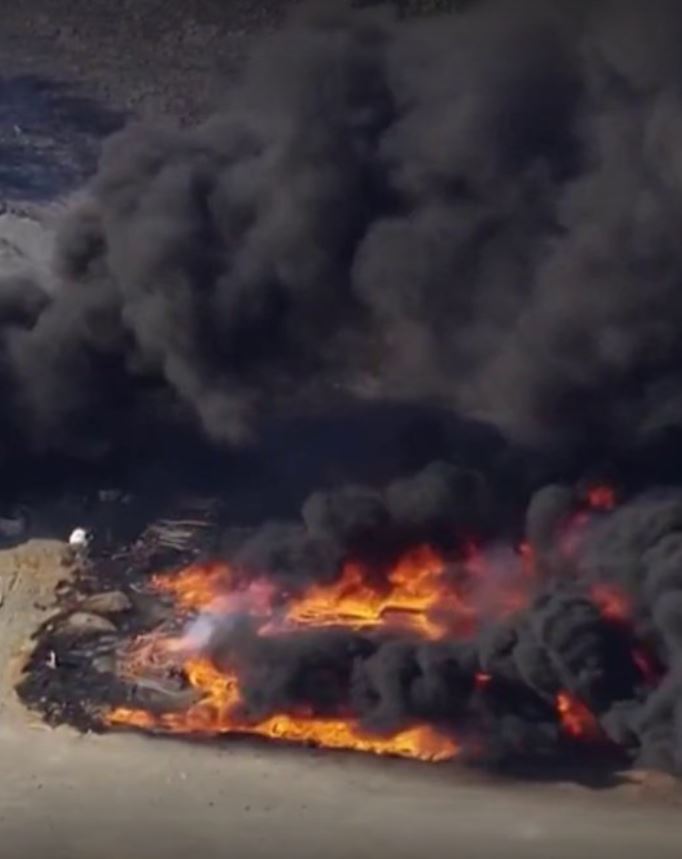 Crews continue to monitor a three-alarm brush fire in Antioch that triggered a public health advisory late Tuesday, Contra Costa County officials say