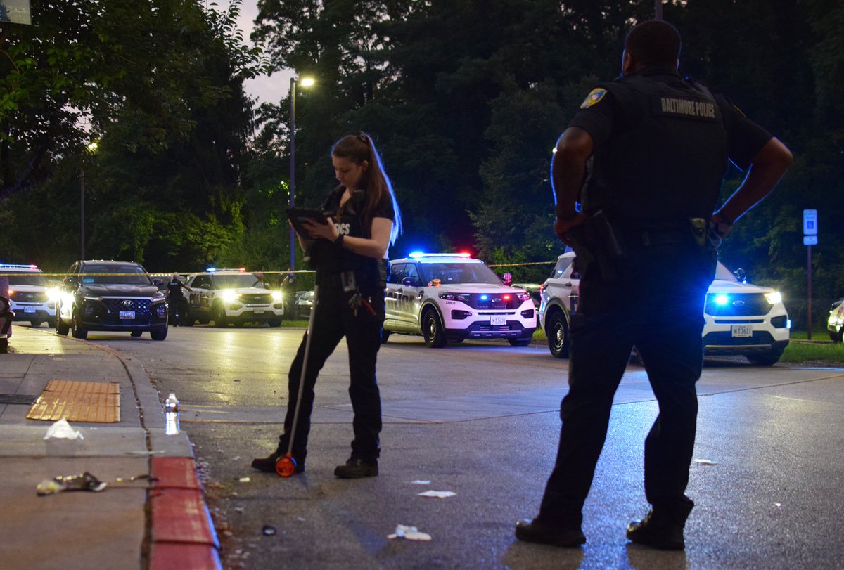 A crime lab technician collects data as part of an investigation into a shooting on Tuesday. The crime scene was in front of one of the entryways to the Bernard E Mason Apartments on Windsor Gardens Lane