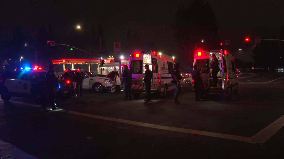 Two people were injured after police say a driver ran a red light, crashing into a pickup truck that was making a turn