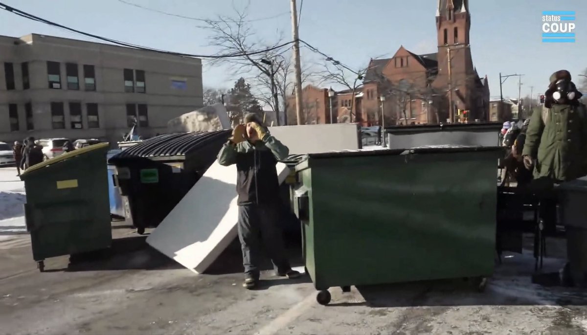 Hundreds of protesters are at the scene of a shooting involving federal agents in Minneapolis. They are blocking the road with large trash bins