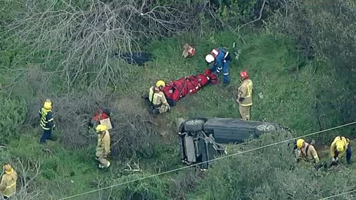 Firefighters set to evacuate injured driver by helicopter after car tumbles down hillside in Studio City crash