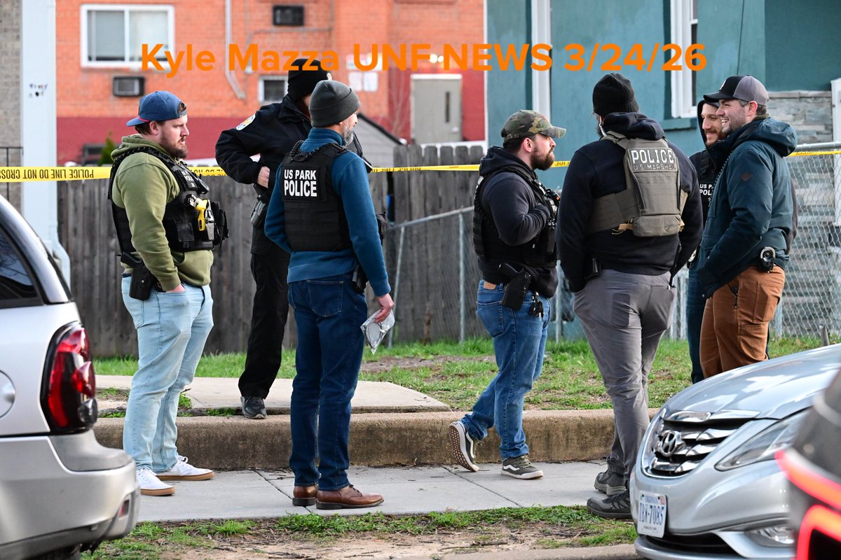 Metropolitan Police Department officers, U.S. Marshals and agents with the Bureau of Alcohol, Tobacco, Firearms and Explosives (ATF) execute a search warrant at the scene where overnight a U.S. Park Police officer was shot in Southeast, Washington, D.C. on March 24, 2026. The officer was shot while inside an unmarked vehicle on the 5000 block of Queens Stroll Place SE
