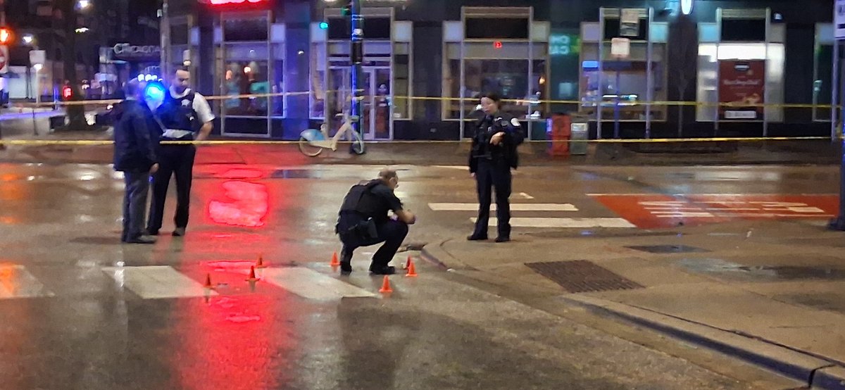 Pedestrian shot during shooting between cars 0-100 block of E. Chicago. Officers responded to a call for service. A 22-year-old male was driving a red sedan when he was approached by a white sedan occupied by an Rush Street somebody shooting out the back window of a car