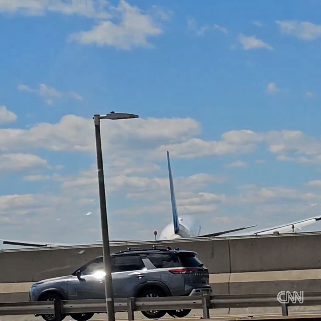 A plane landing at Newark Liberty International Airport hit a streetlight and a tractor-trailer on the nearby highway, injuring the truck’s driver, according to the New Jersey State Police