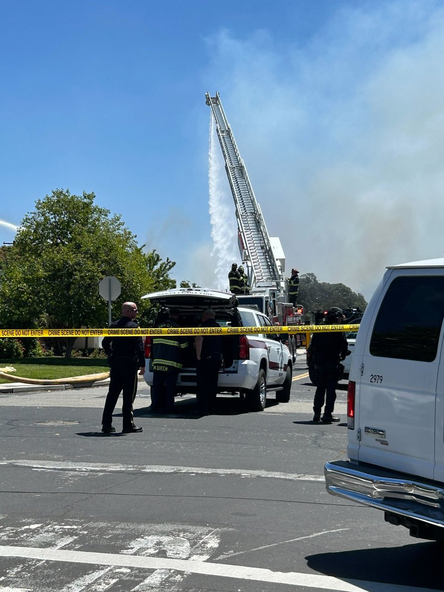 Investigation ongoing after victim shot & killed on Enright & nearby home erupts into flames, drawing SWAT teams & armored vehicles to neighborhood