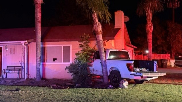 A late-night crash sent a pickup truck into the living room of a Visalia home, and police said the driver ran before being caught nearby.