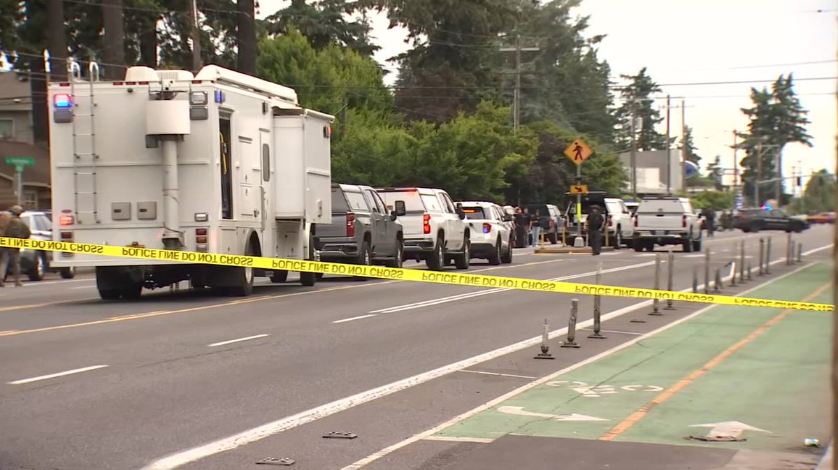 Portland police say a woman who was being held in an apartment with an armed suspect has been released and is safe; suspect remains barricaded